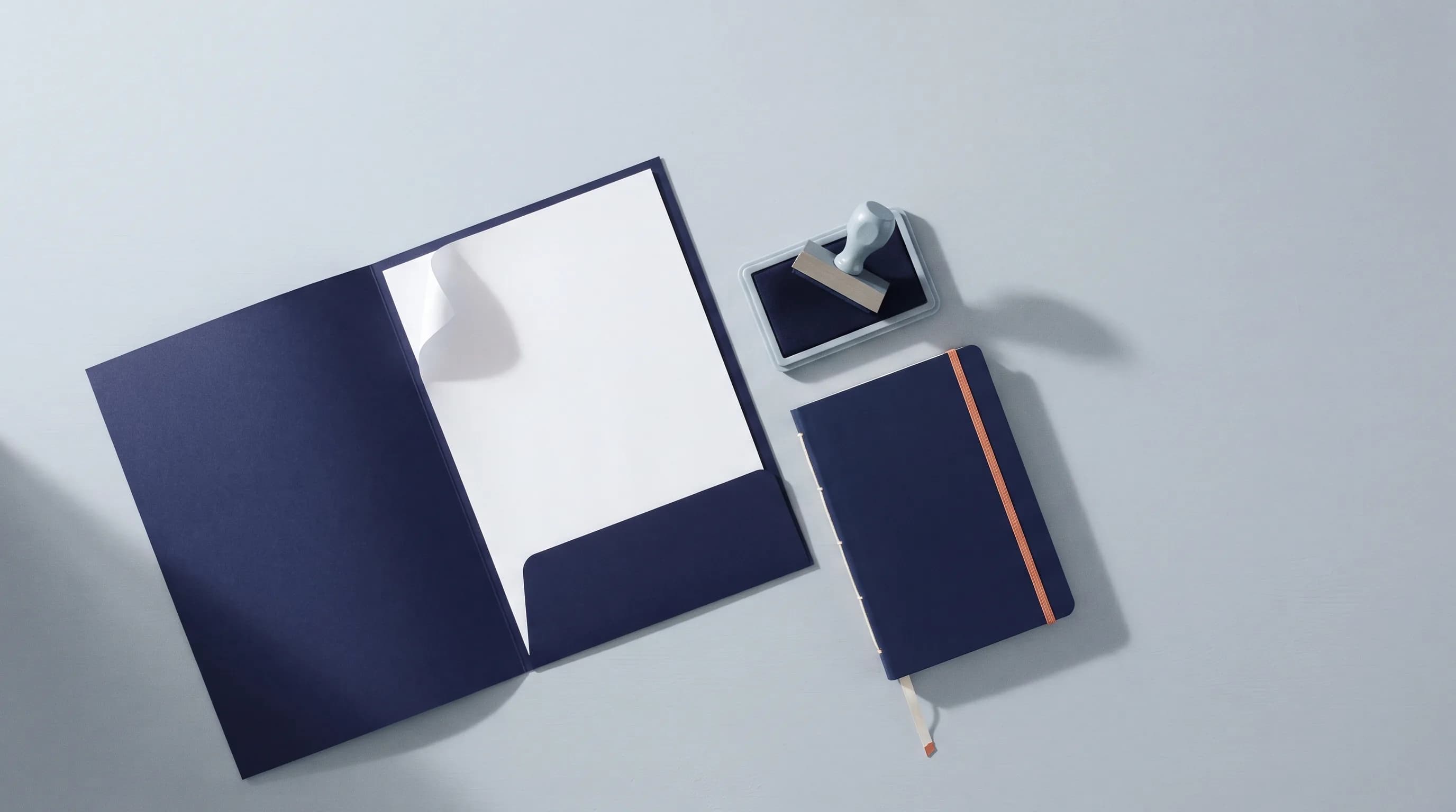 A printed quotation in an open folder, a date stamp on its pad and a follow-up notebook.